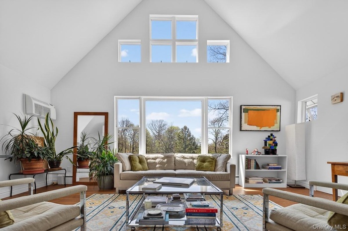 Living room with wall of windows overlooking Hudson River