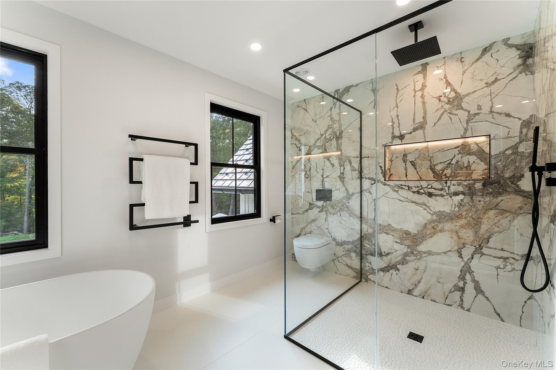 Full bath with a marble finish shower, a freestanding tub, recessed lighting, and tile patterned floors