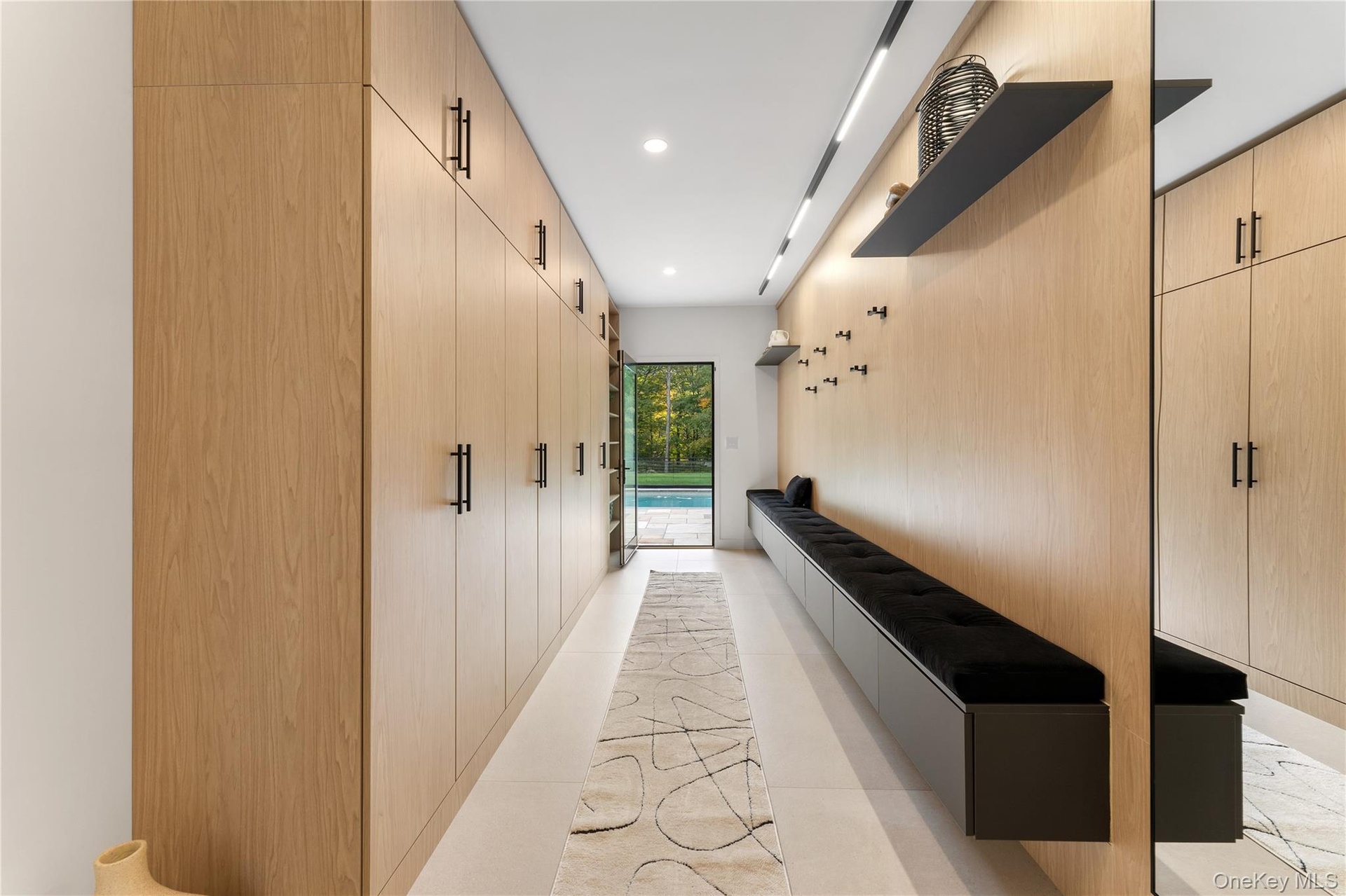 Mudroom leading from the pool featuring recessed lighting
