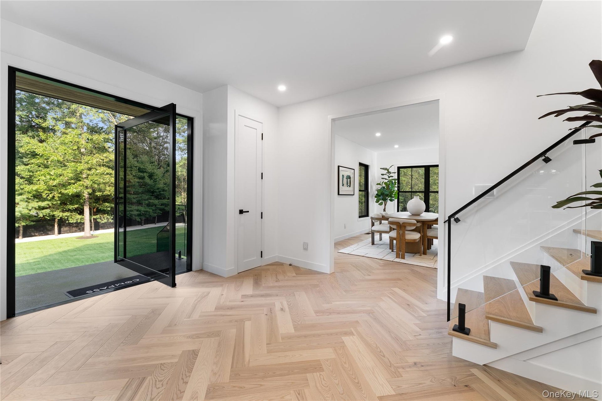 Entryway with recessed lighting and stairs