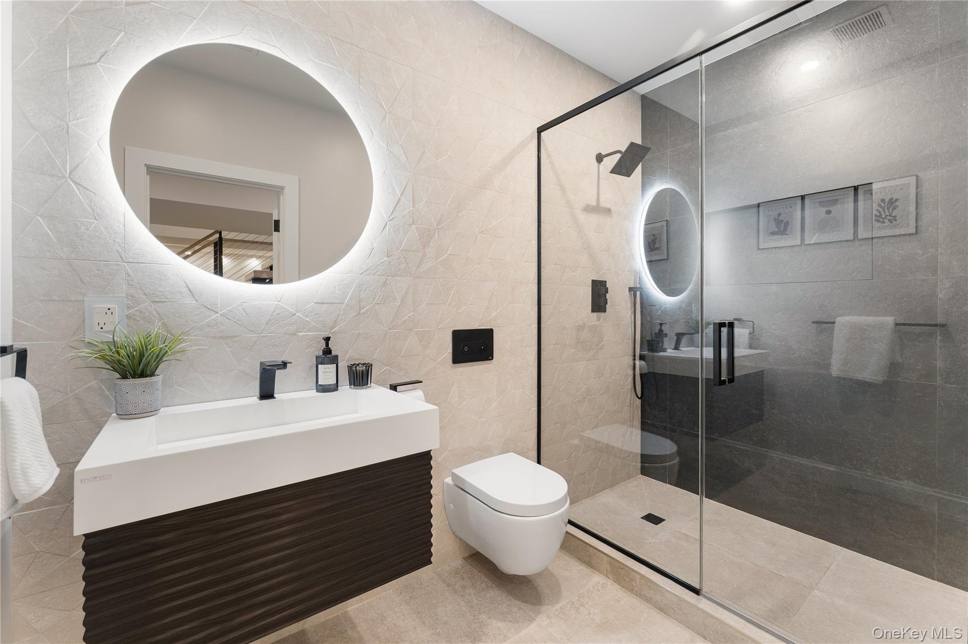 Full bathroom with tile walls, vanity, a stall shower, and tile patterned flooring