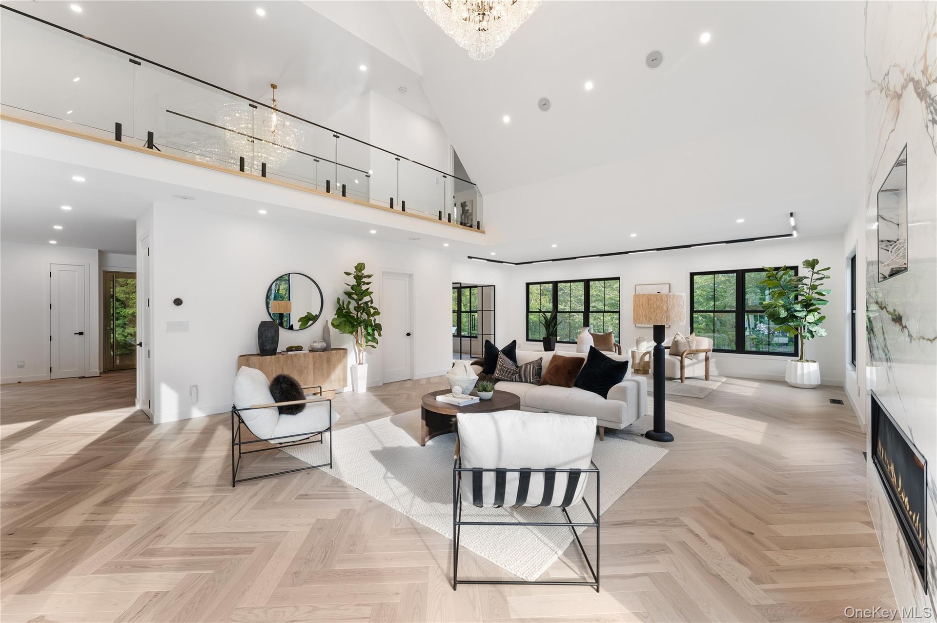 Living room with recessed lighting, high vaulted ceiling, a premium fireplace, and a chandelier