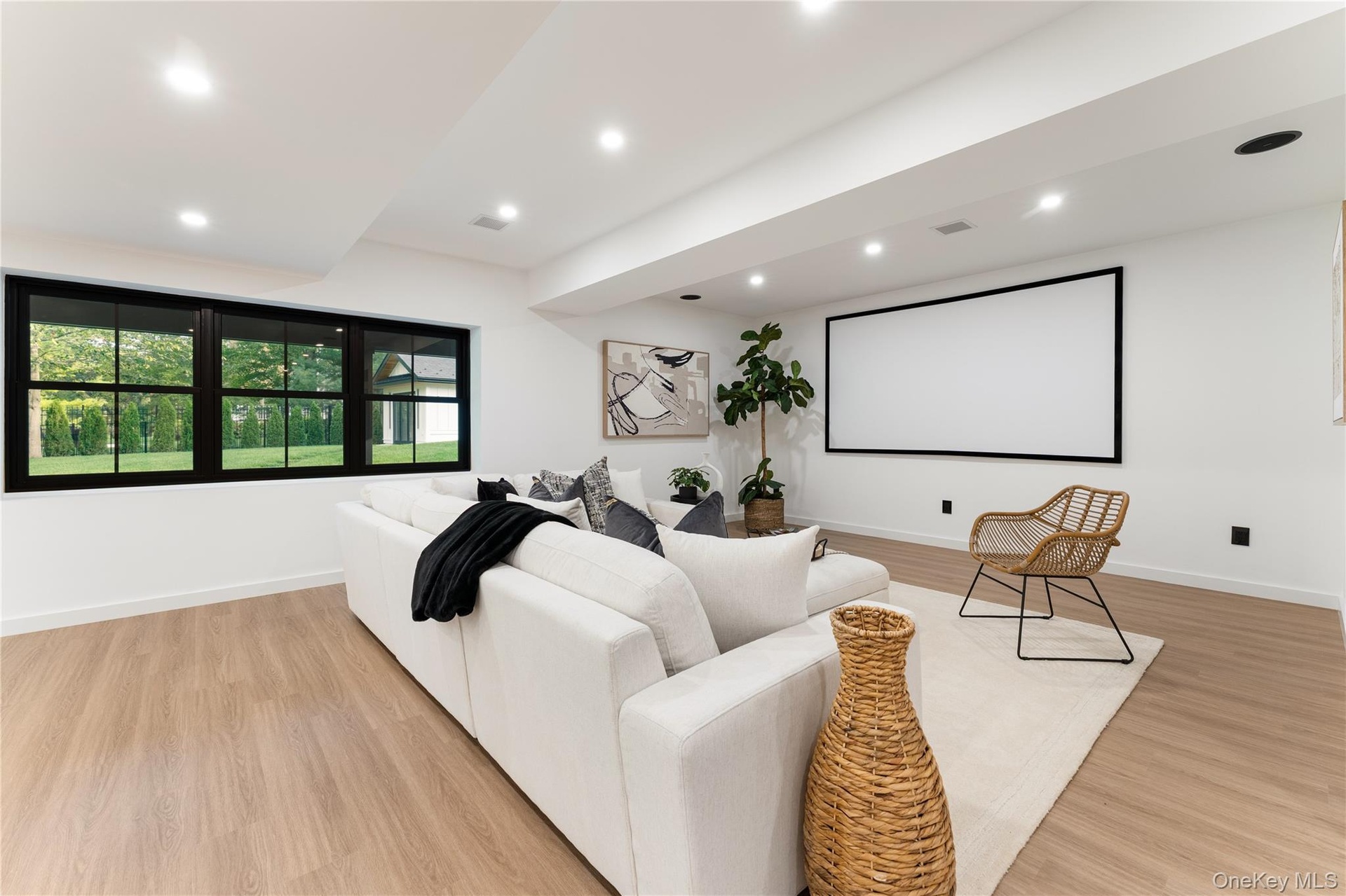 Home theater with recessed lighting and light wood-style floors
