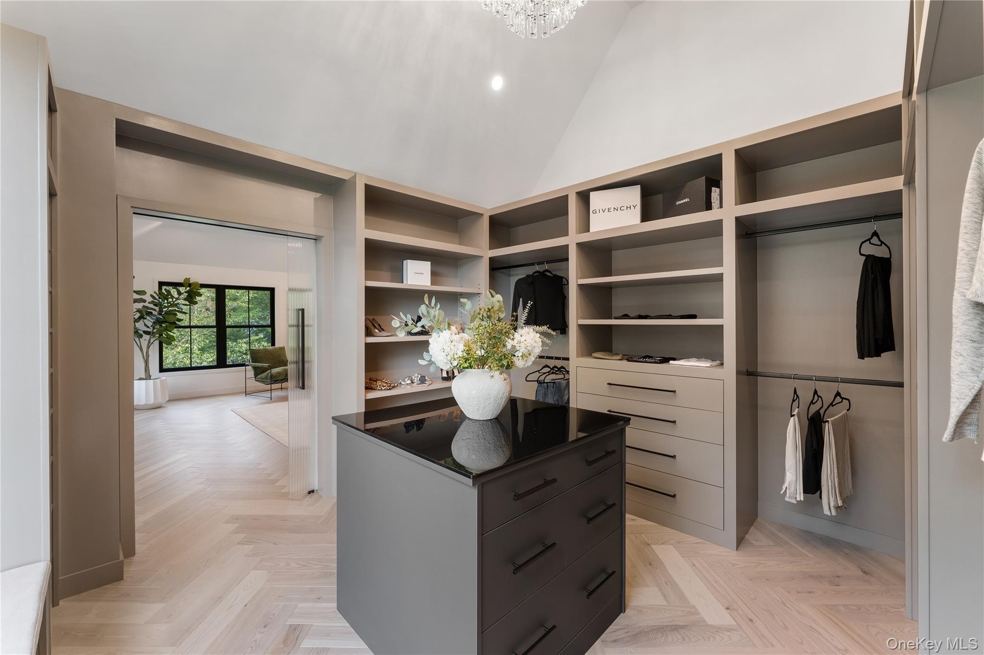 Spacious closet featuring high vaulted ceiling