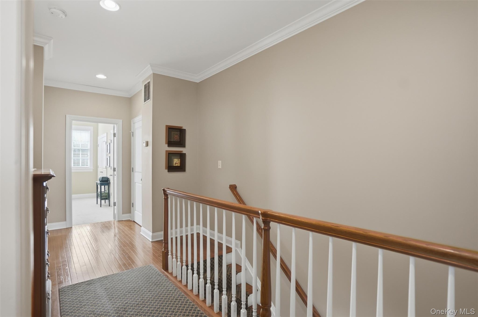 Hardwood oak flooring continues upstairs through the hallway.