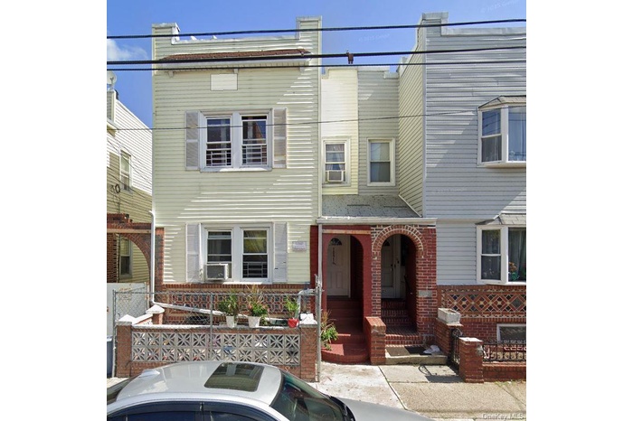 Townhome / multi-family property featuring brick siding and cooling unit