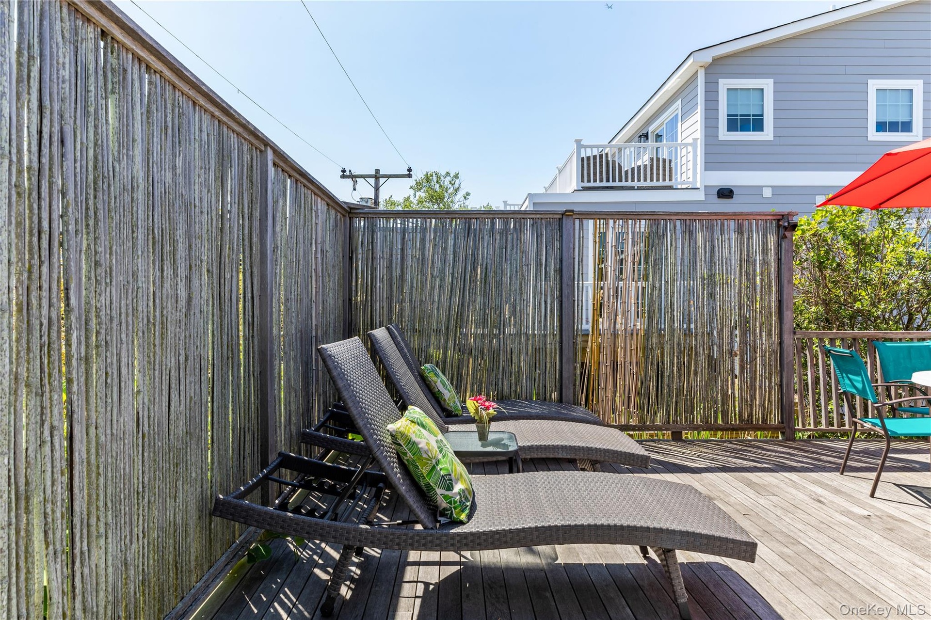 Outdoor wood deck featuring a bamboo privacy screen