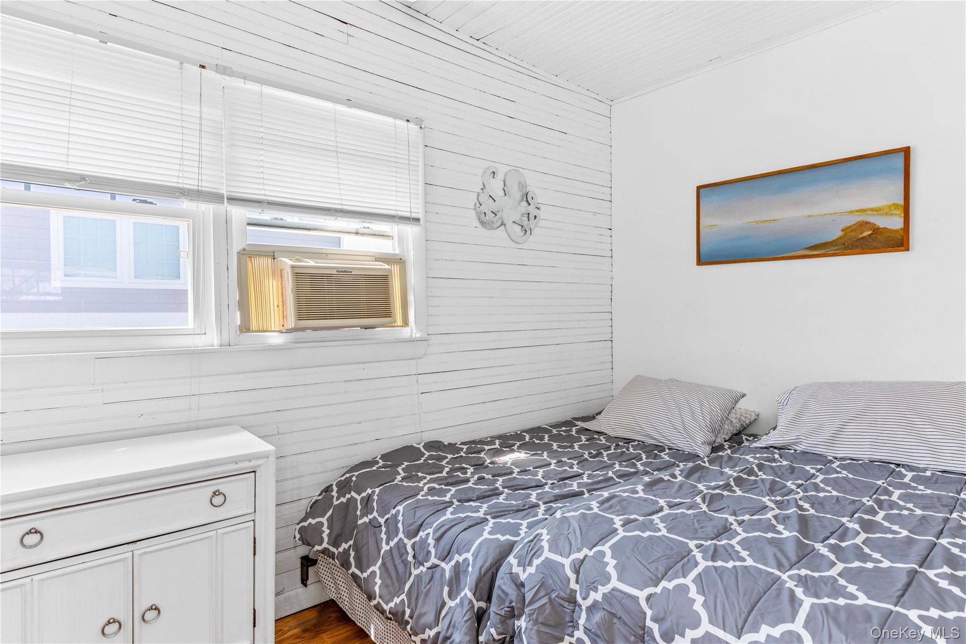 Room featuring white shiplap walls, smooth white ceiling, and a window air conditioning unit