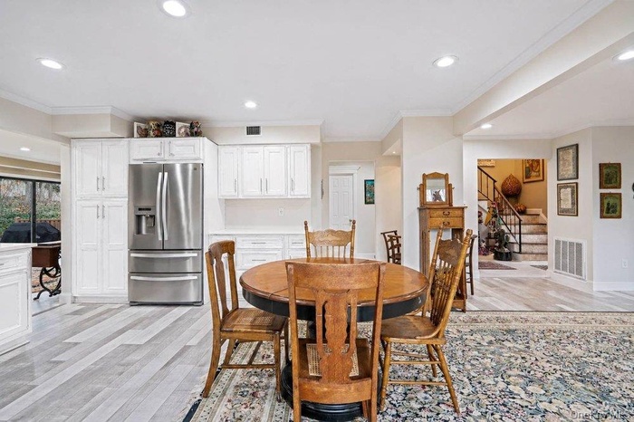 new white kitchen opened to den