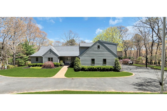 Contemporary-style residence with gray horizontal siding and a light gray shingle roof