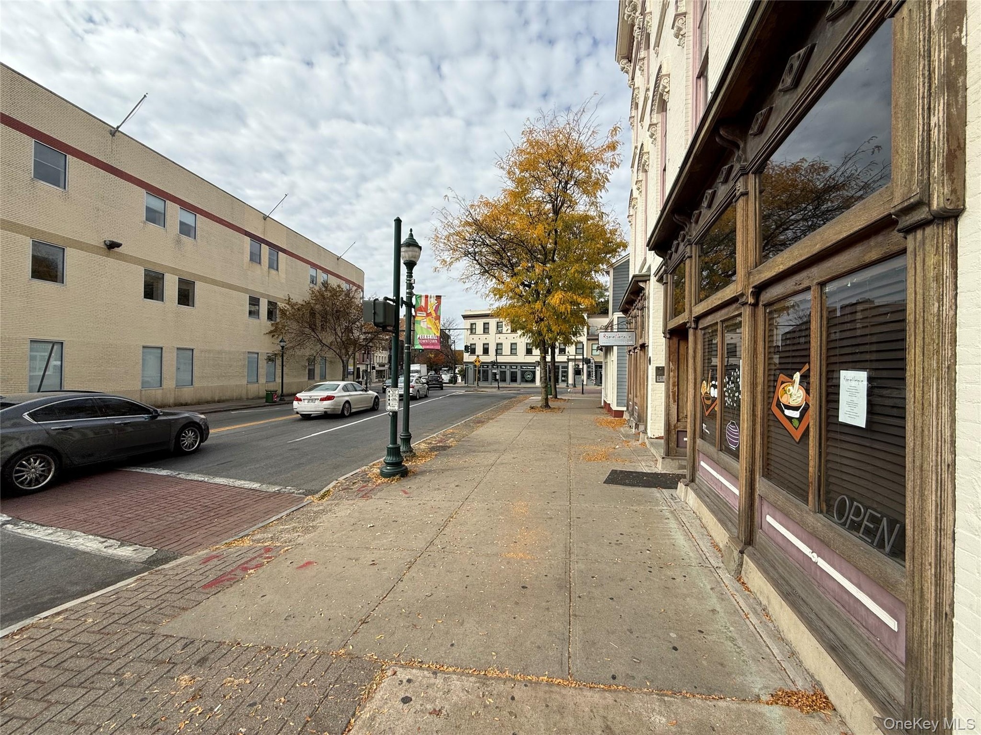 View of street featuring curbs, street lighting, and sidewalks