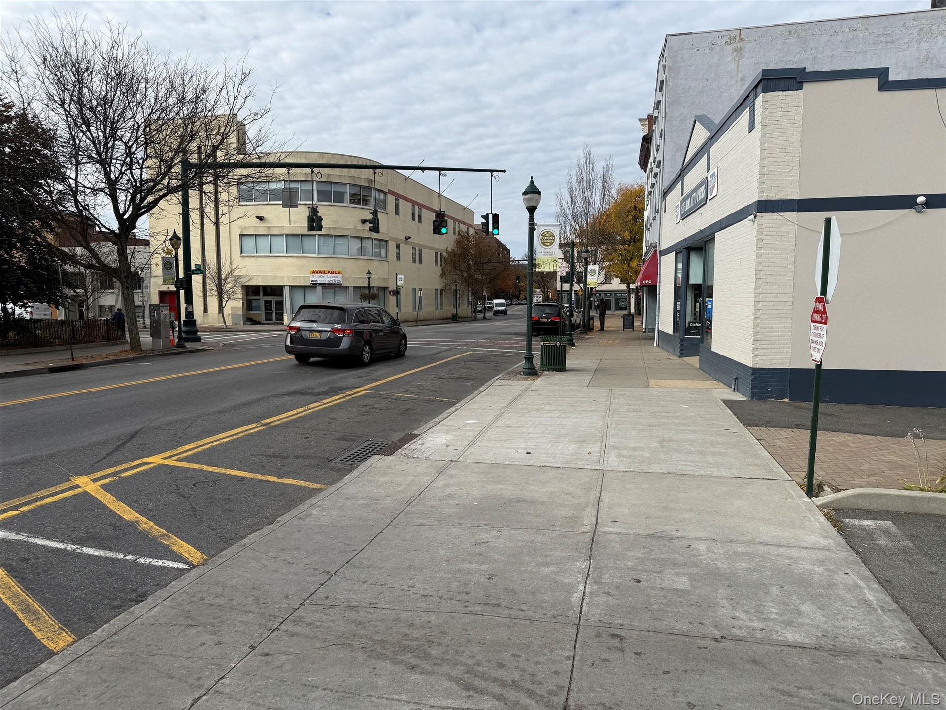 View of street with sidewalks, street lights, traffic signs, and curbs