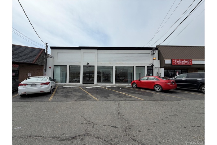 View of building exterior featuring uncovered parking
