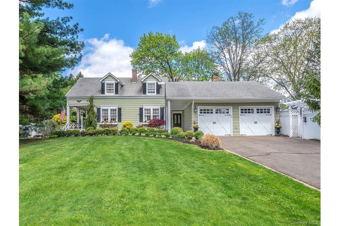 Front view of the home with large front lawn and landscaping