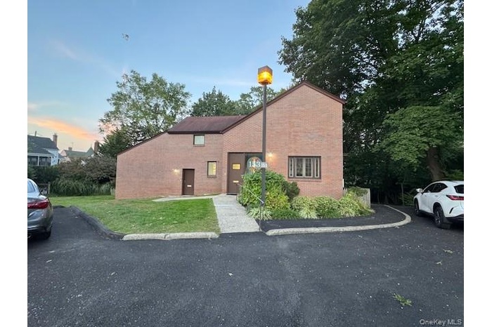 Brick exterior with peak roofline offering character and curb appeal.
