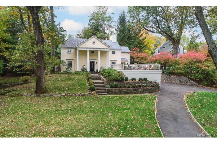 Welcome to 94 Round Hill Road in Old Edgemont-- Beautifully positioned behind a long circular driveway and nestled in the heart of Old Edgemont and wi