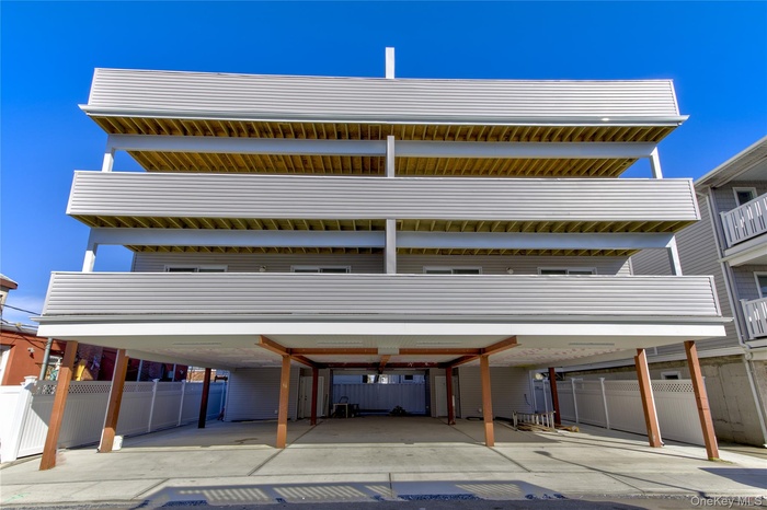 View of parking / parking lot featuring fence