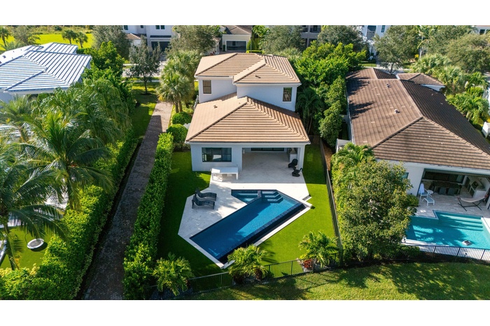 Spacious backyard with artificial turf for care free maintenance.