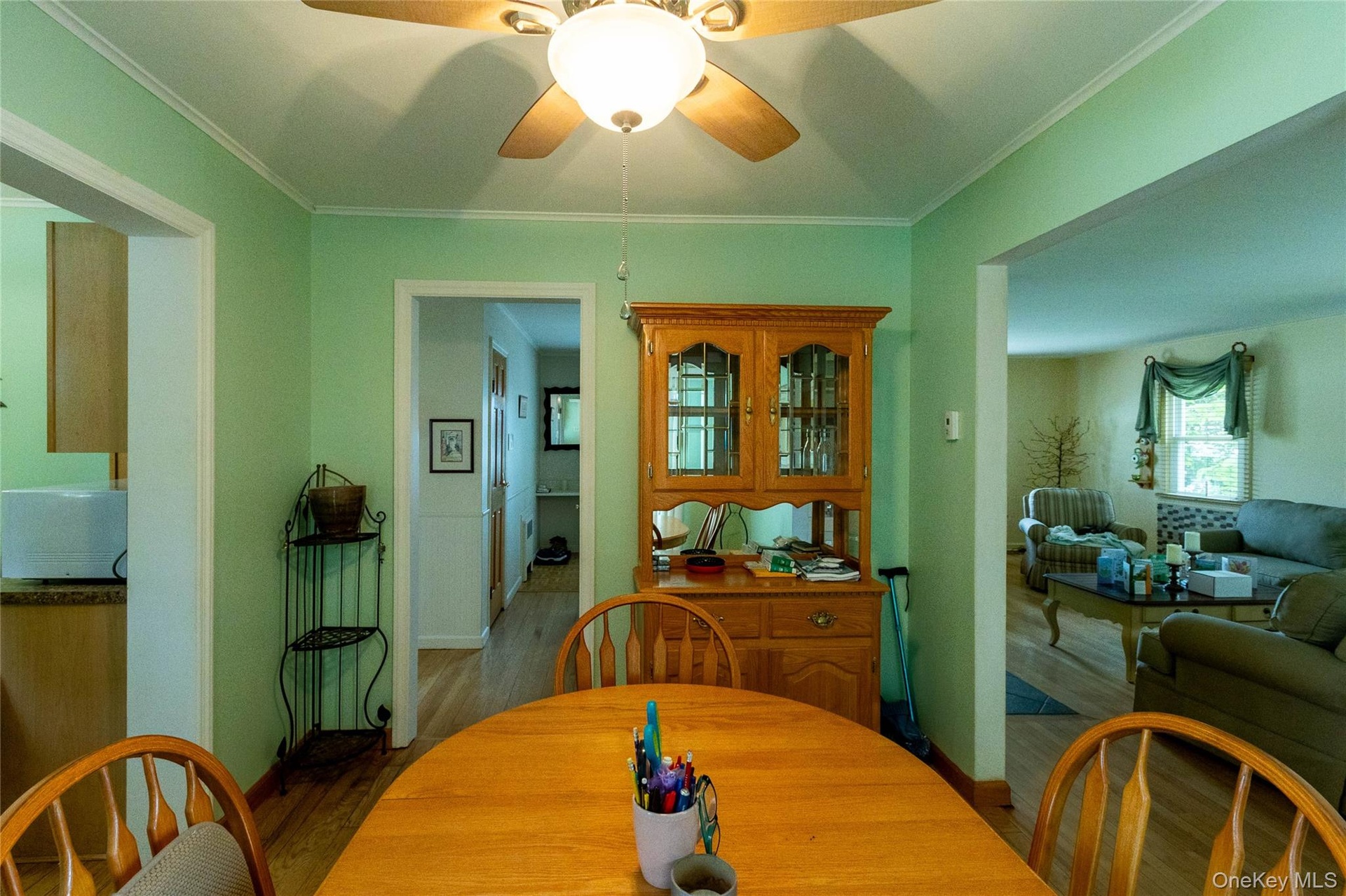 Dining area featuring wood-finish flooring and a ceiling fan with integrated lighting
