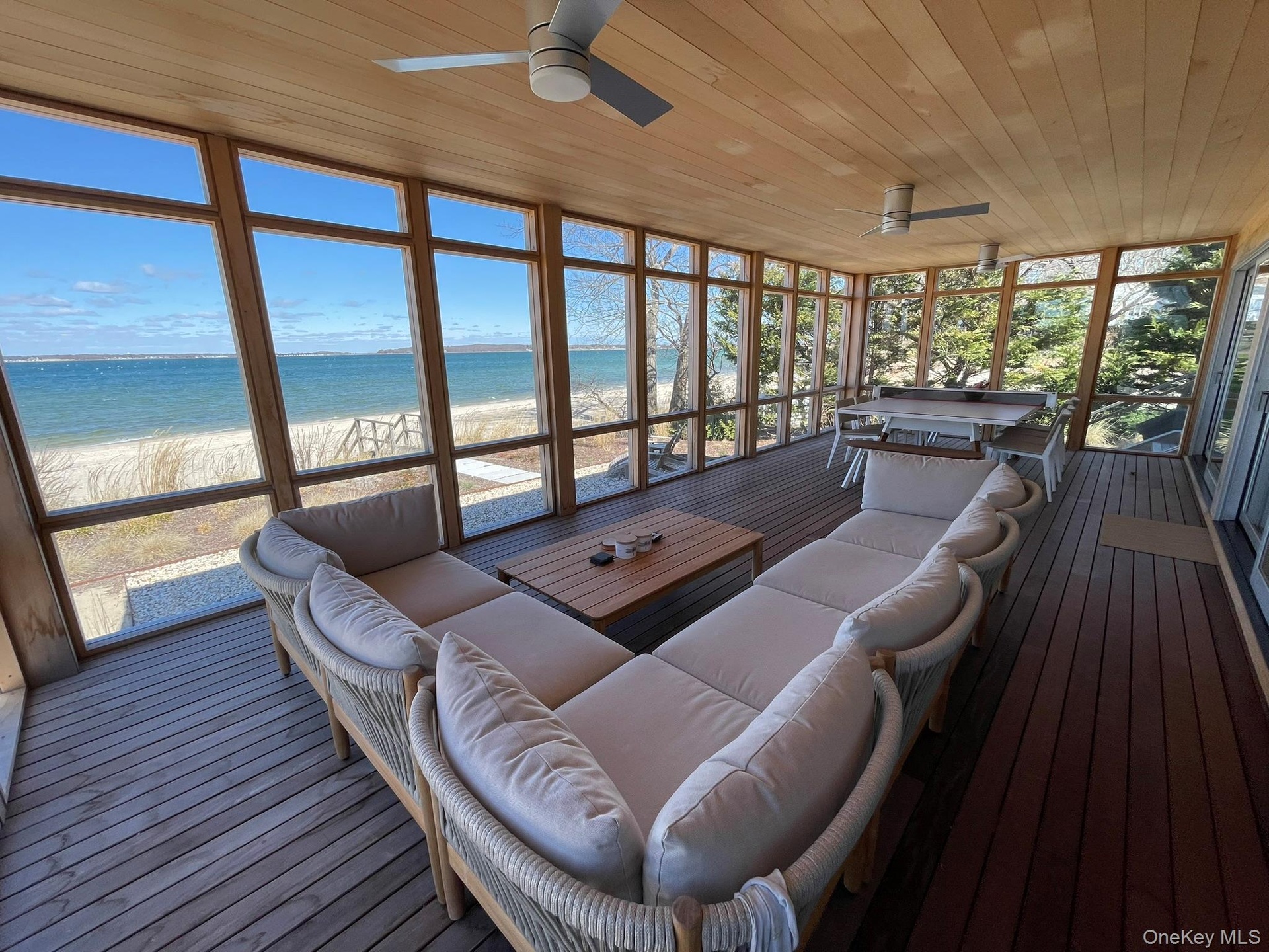 Sunroom featuring a water view, an outdoor hangout area, and ceiling fan