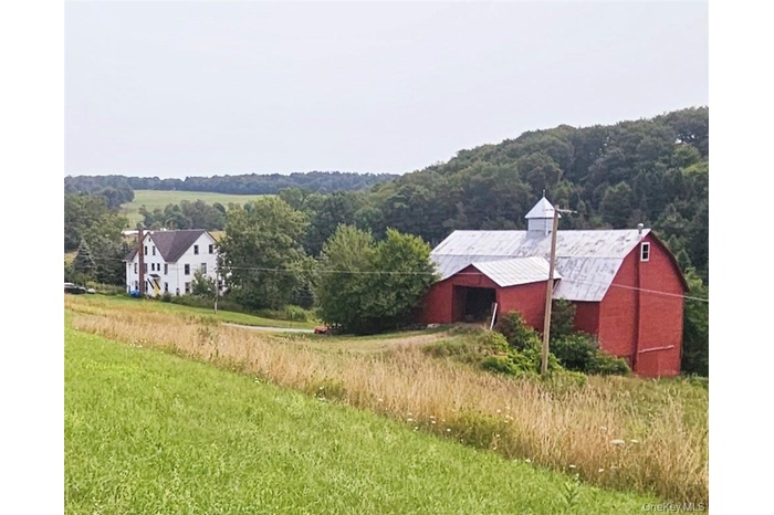 View of yard featuring a rural view and an outbuilding