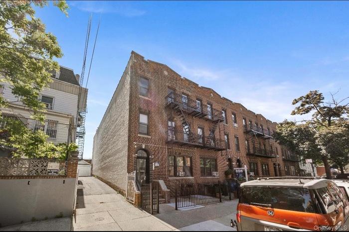 View of apartment building / complex featuring a fenced front yard