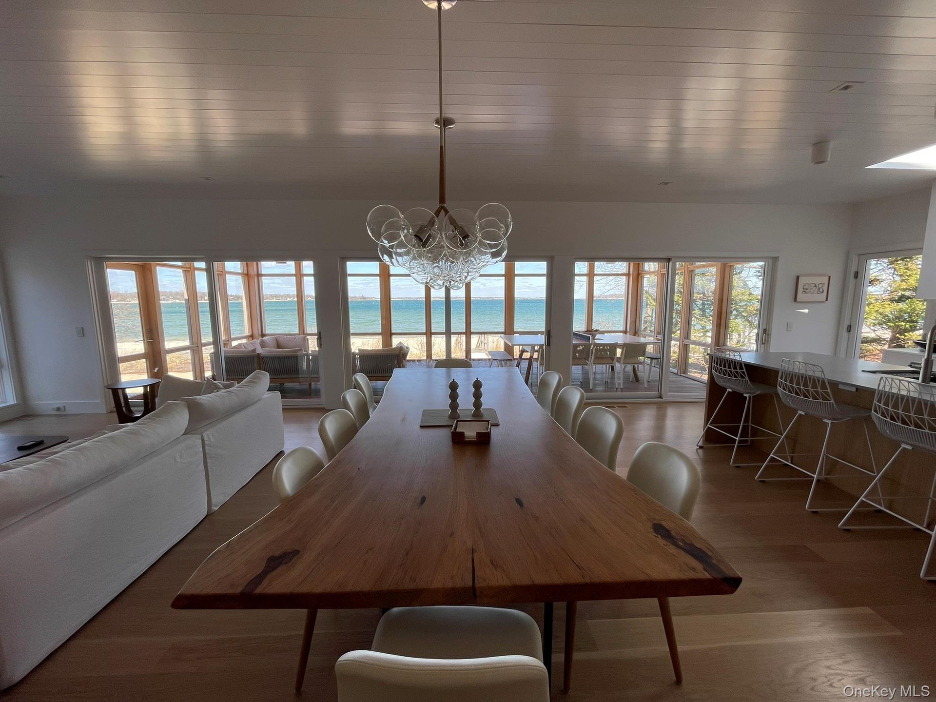 Dining room with a water view, an inviting chandelier, and wood finished floors