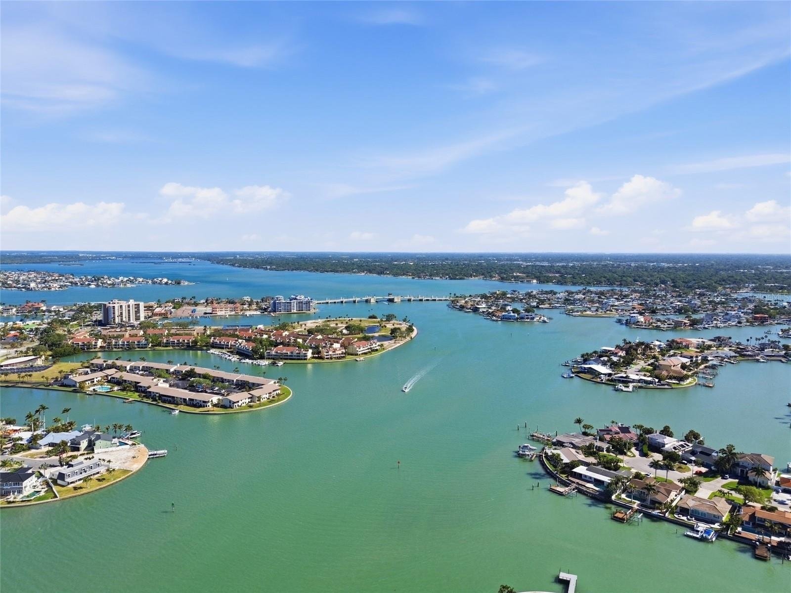Aerial photo high above 4 Bellevue looking northwest towards Treasure Island Causeway drawbridge allowing access to the Gulf for sailboats and larger 