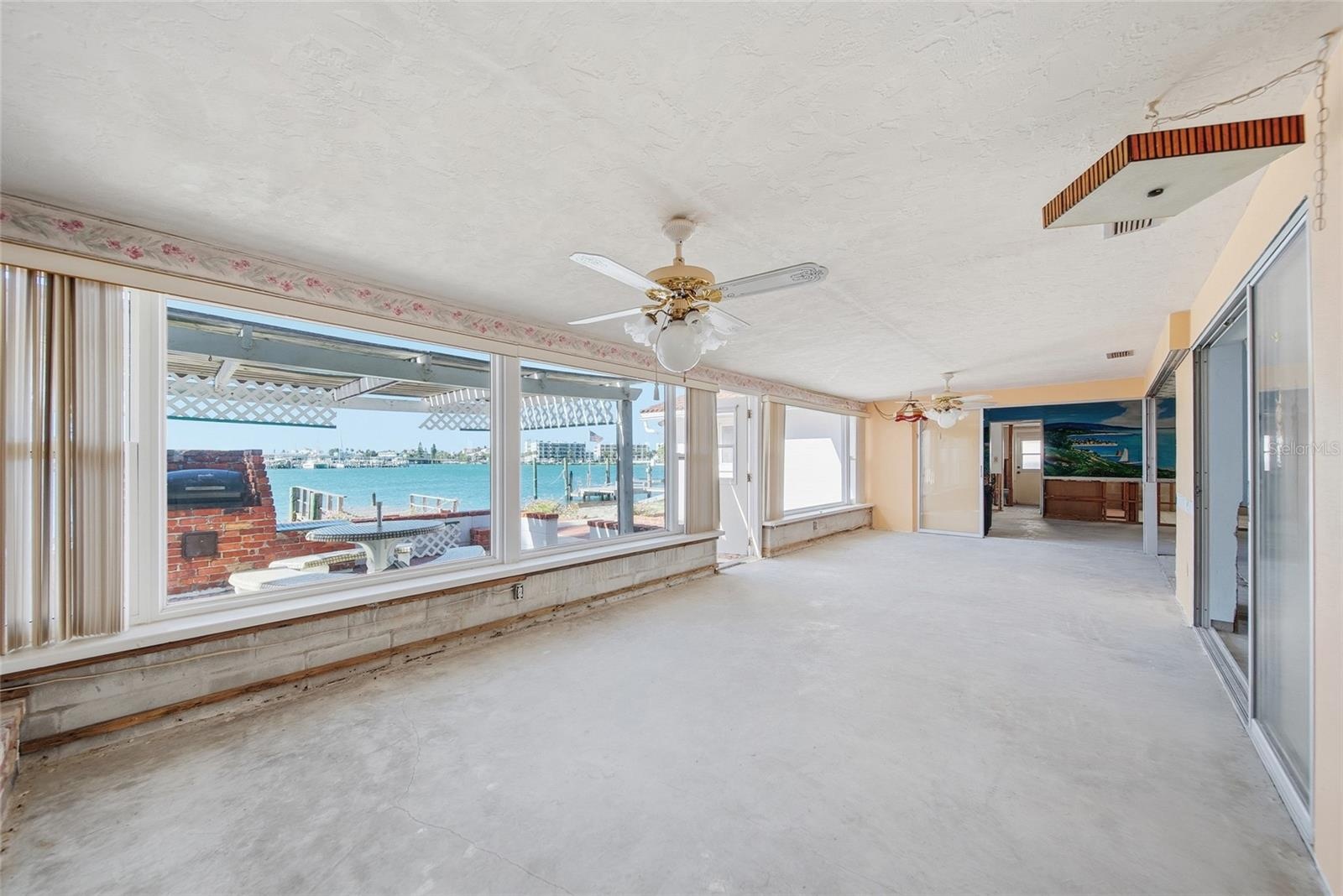 View from family room looking south towards the turquoise waters of the Intracoastal.  The existing kitchen area, living room, dining room, family roo