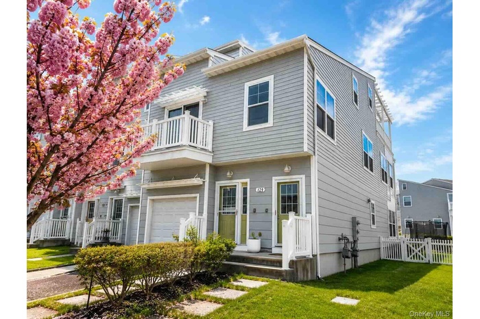 Multi-level exterior with light gray siding and white trim