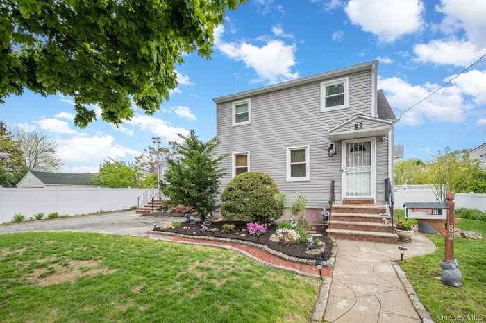 Two-story residence featuring gray siding and white trim windows