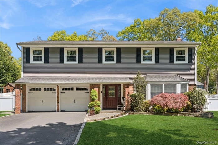 Professionally landscaped, outdoor lighting. New garage doors.