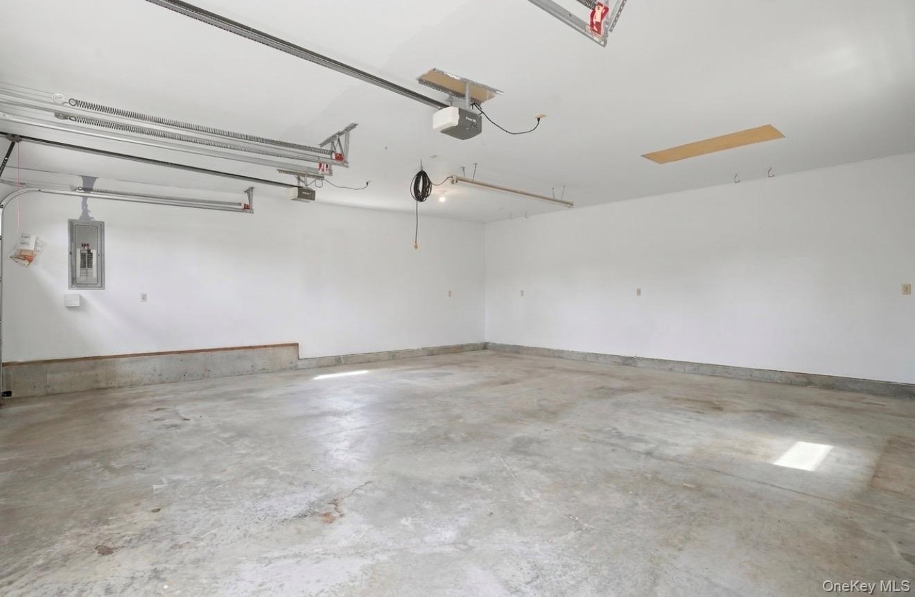 2 car garage. Staged empty for your imagination. Fully insulated. Electric charging station.