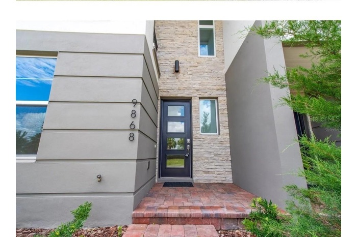 Front Entrance with lovely stone work and Contemporary door, all exterior HOA maintained
