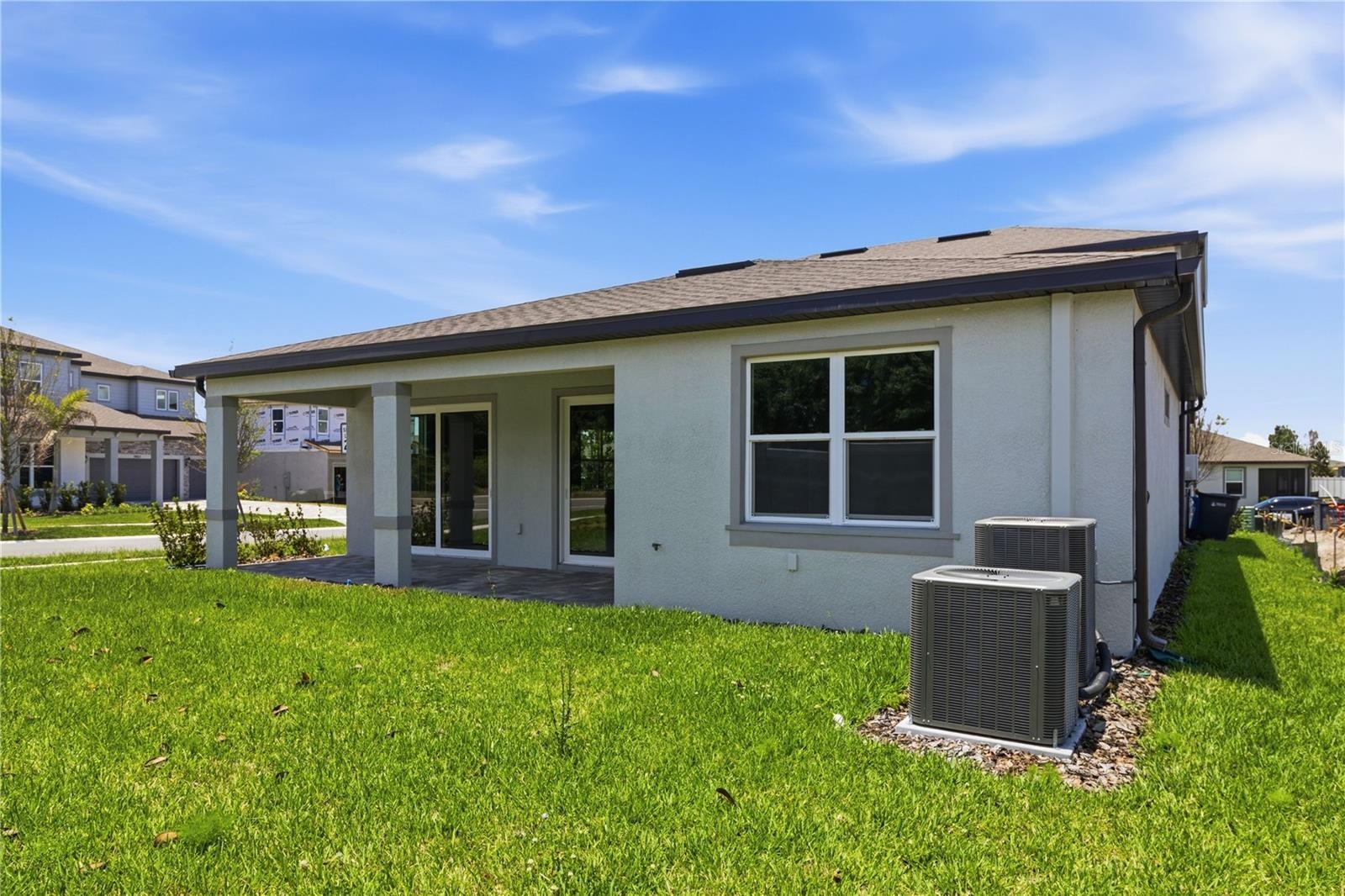 Rear exterior view with covered lanai space and room to enjoy the backyard.