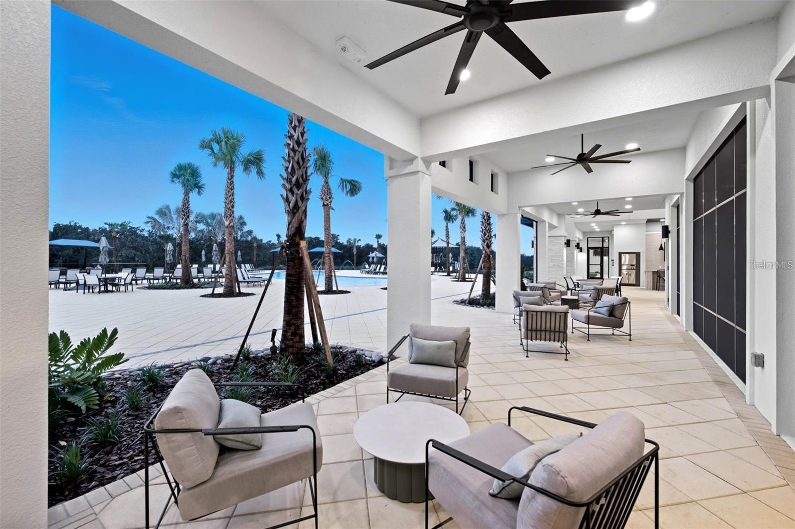 Covered outdoor lounge space designed for shade, comfort, and easy Florida living.