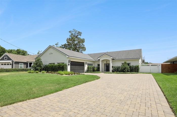 With its expansive stone-pavered driveway, and stately entrance - 24 Minnehaha Cir. makes an unforgettable first impression in one of Maitland’s most 