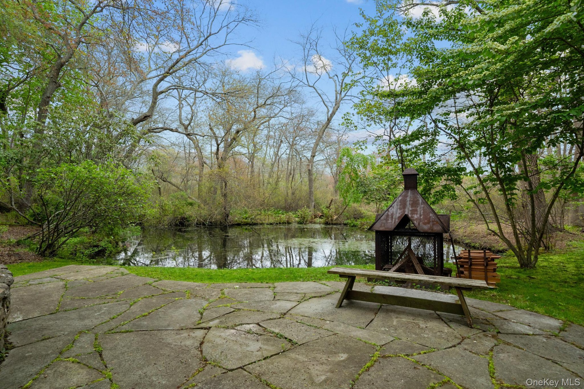 Custom Fire pit stone patio overlooking the pond