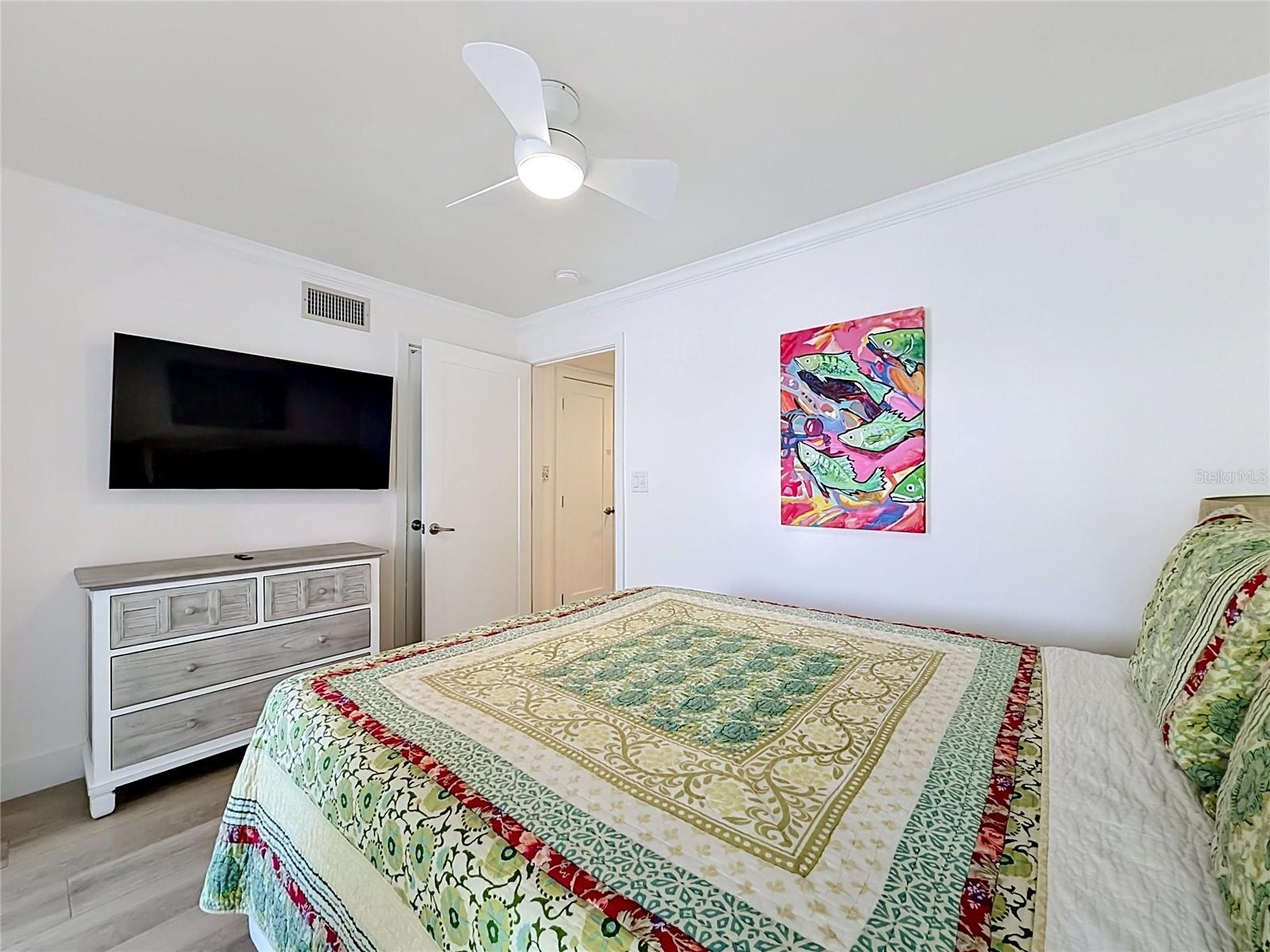Another look at the 2nd bedroom that does have a television mounted on the wall that conveys with the sale