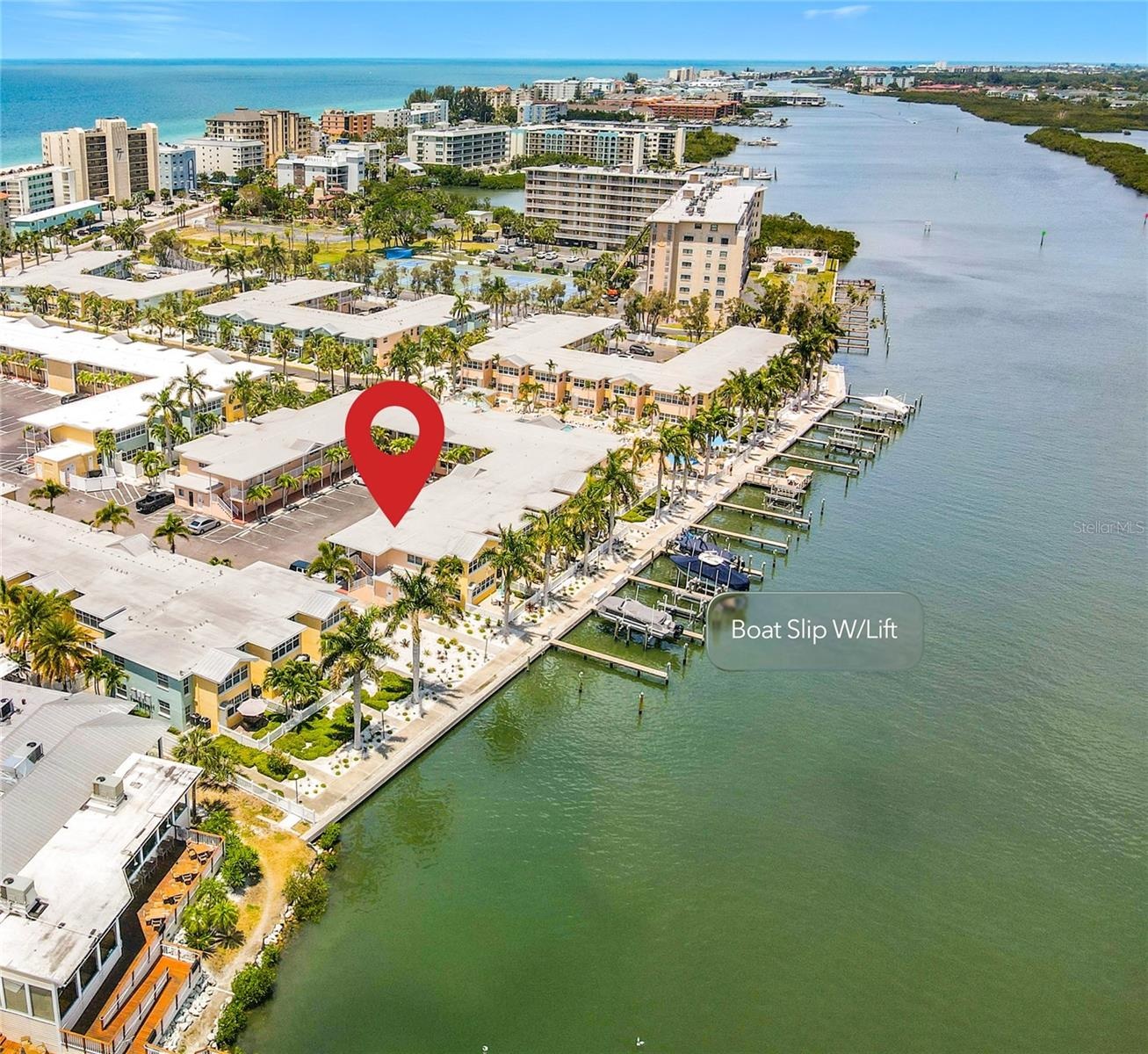 This aerial view shows the unit location and the boat slip with lift location that conveys with this unit.
