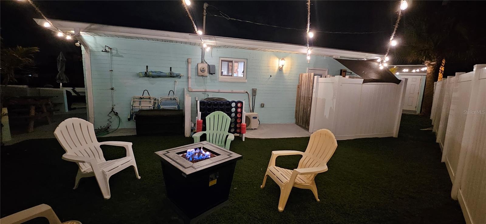 side yard with full outdoor shower and fire pit