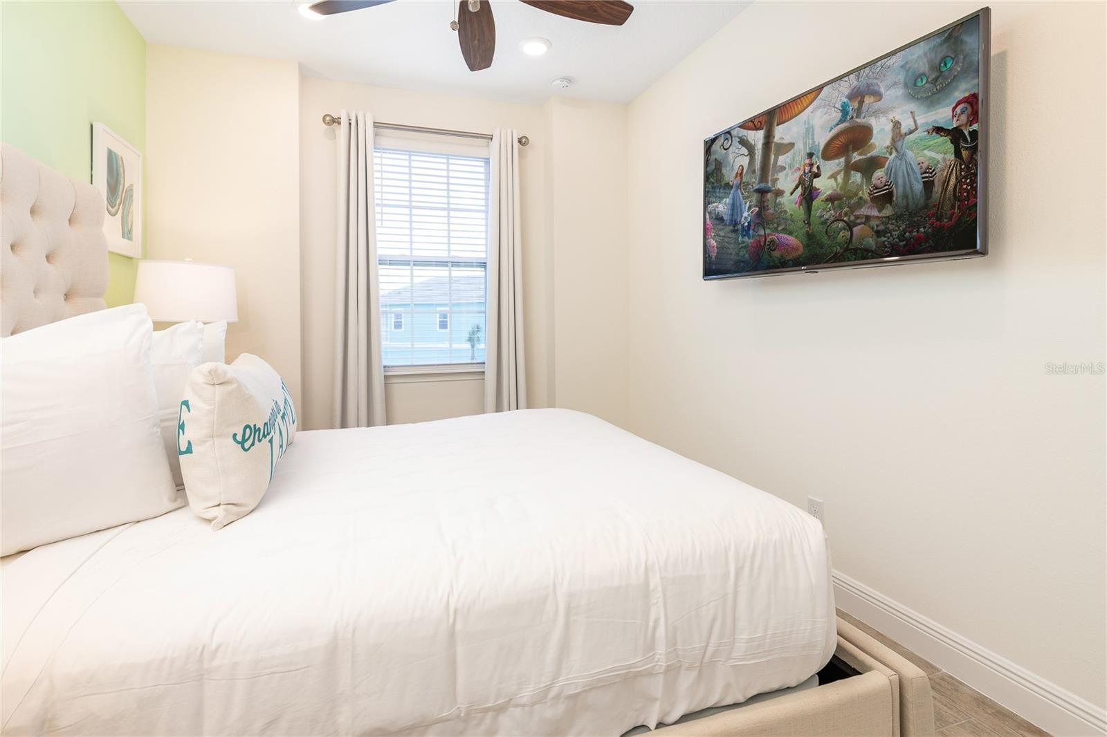 Bedroom with neutral tones and natural light in Kissimmee vacation home