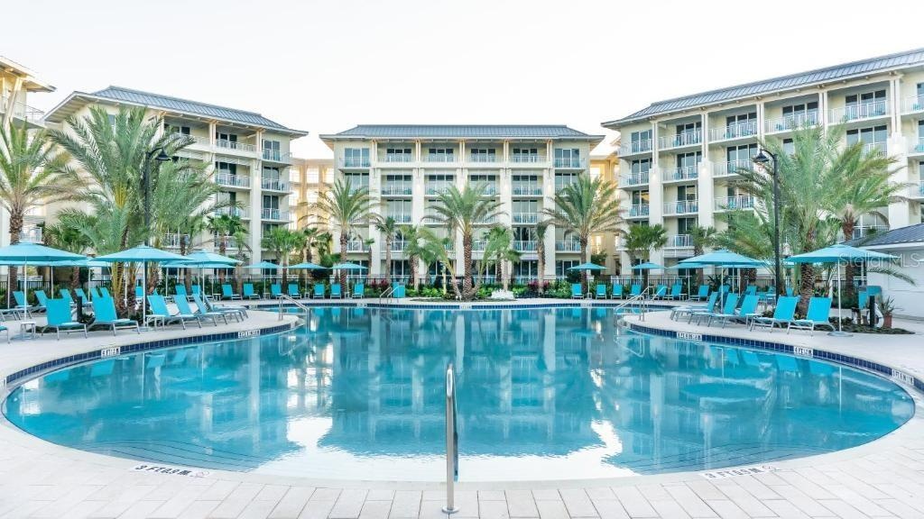Large resort pool surrounded by tropical landscaping in Kissimmee Florida