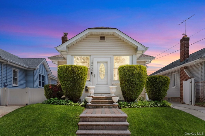 Light-colored siding exterior with a pitched roof