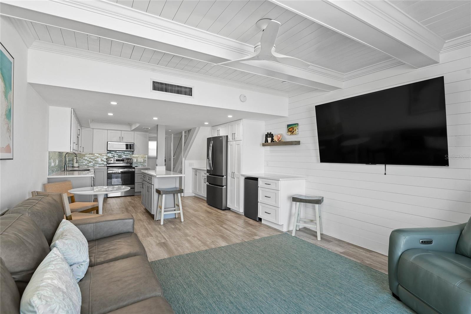Great Room w/ custom paneling and beamed ceilings. Open Floor Plan.