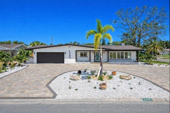 Welcome home to a stunning residence that immediately impresses with its elegant circular paver driveway & impeccable curb appeal.
