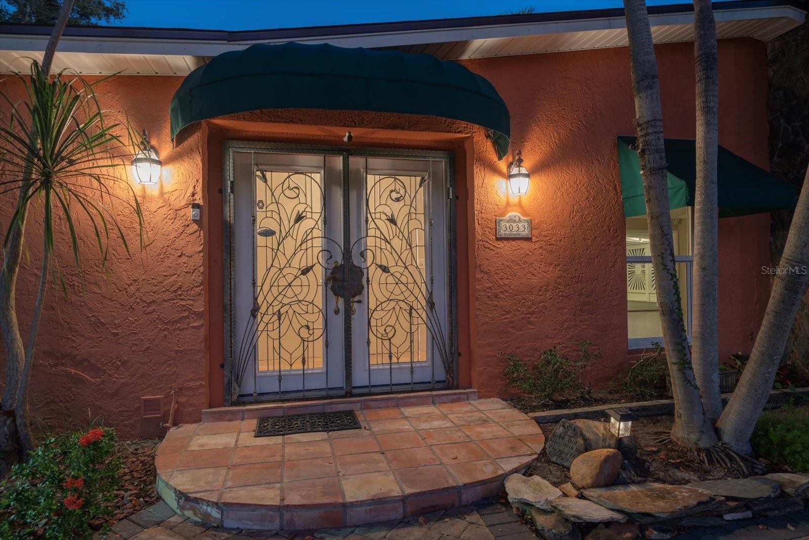 CUSTOM WROUGHT IRON - DOUBLE LEADED GLASS DOOR COVERED ENTRY WAY WITH STONE PAVER PORCH