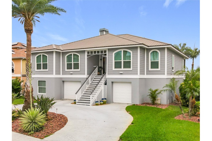 Welcome to your waterfront oasis! This captivating front exterior showcases beautiful landscaping and offers extra parking, perfect for embracing the 
