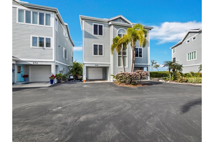 Freestanding home with two deep garages and a private entrance..preserve and Sarasota Bay are on the other side...check out more photos!