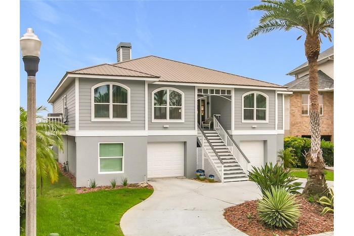 Welcome to your waterfront oasis! This captivating front exterior showcases beautiful landscaping and offers extra parking, perfect for embracing the 